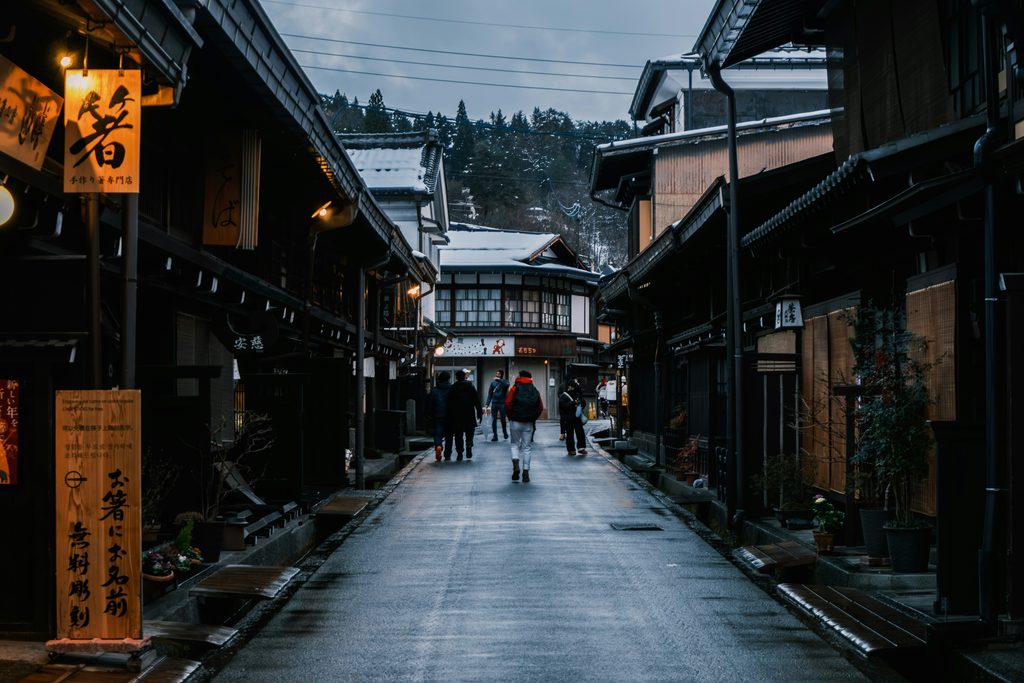 Snowy street in Takayama's old town lined with traditional wooden houses